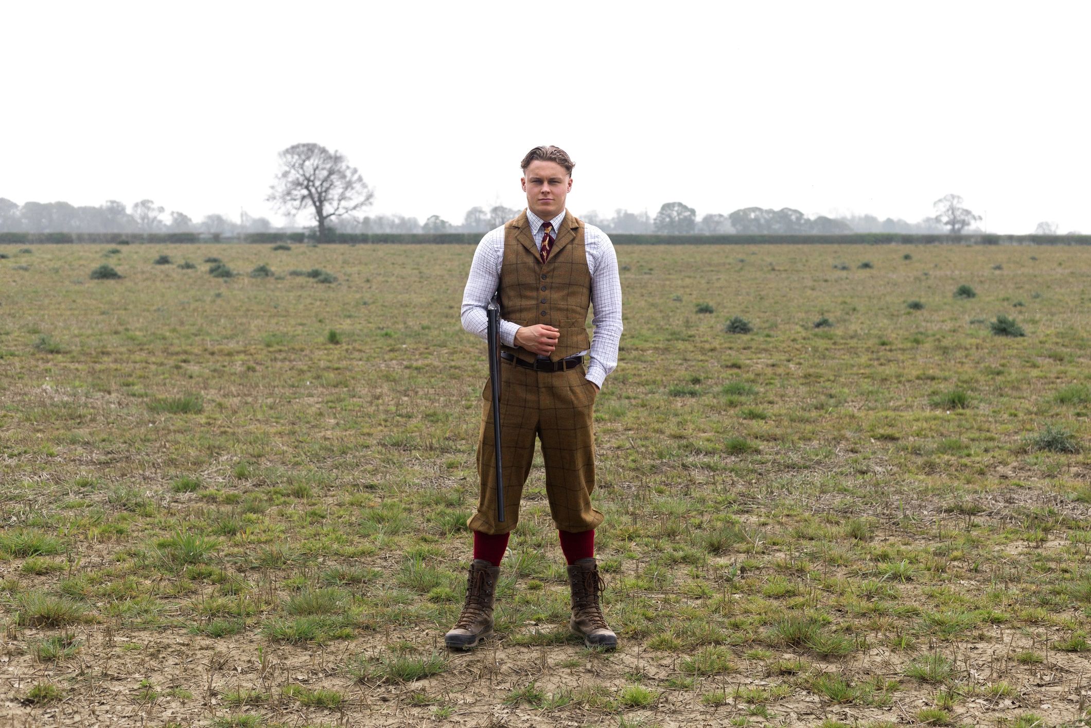 Man dressed in formal tuxedo-style attire outdoors
